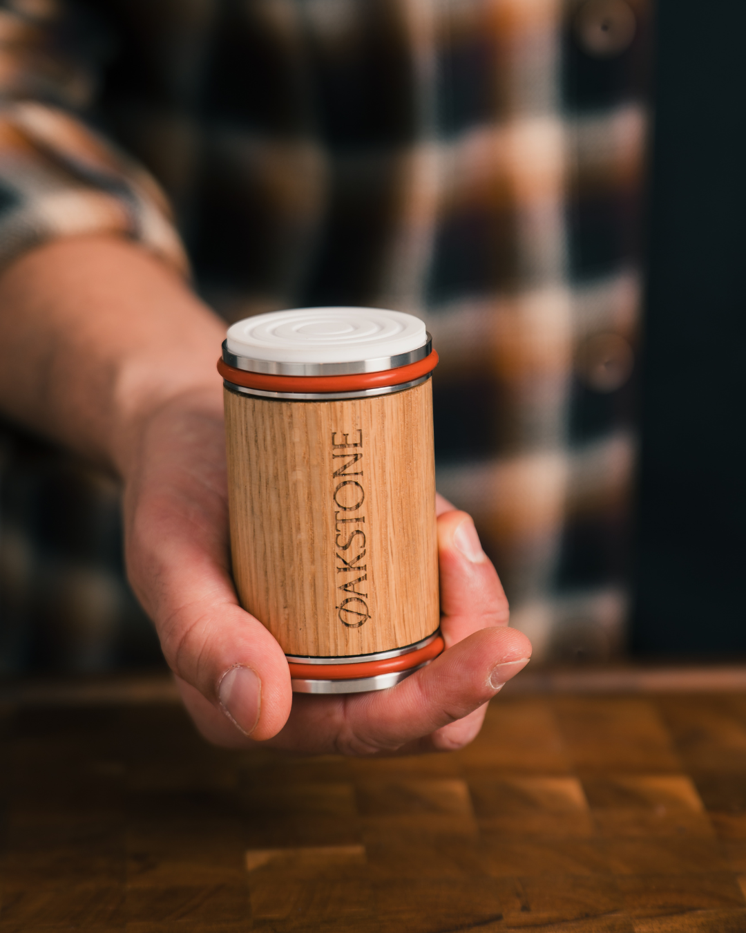 Hand holding the Oakstone oak roller with the white ceramic honing disc facing up