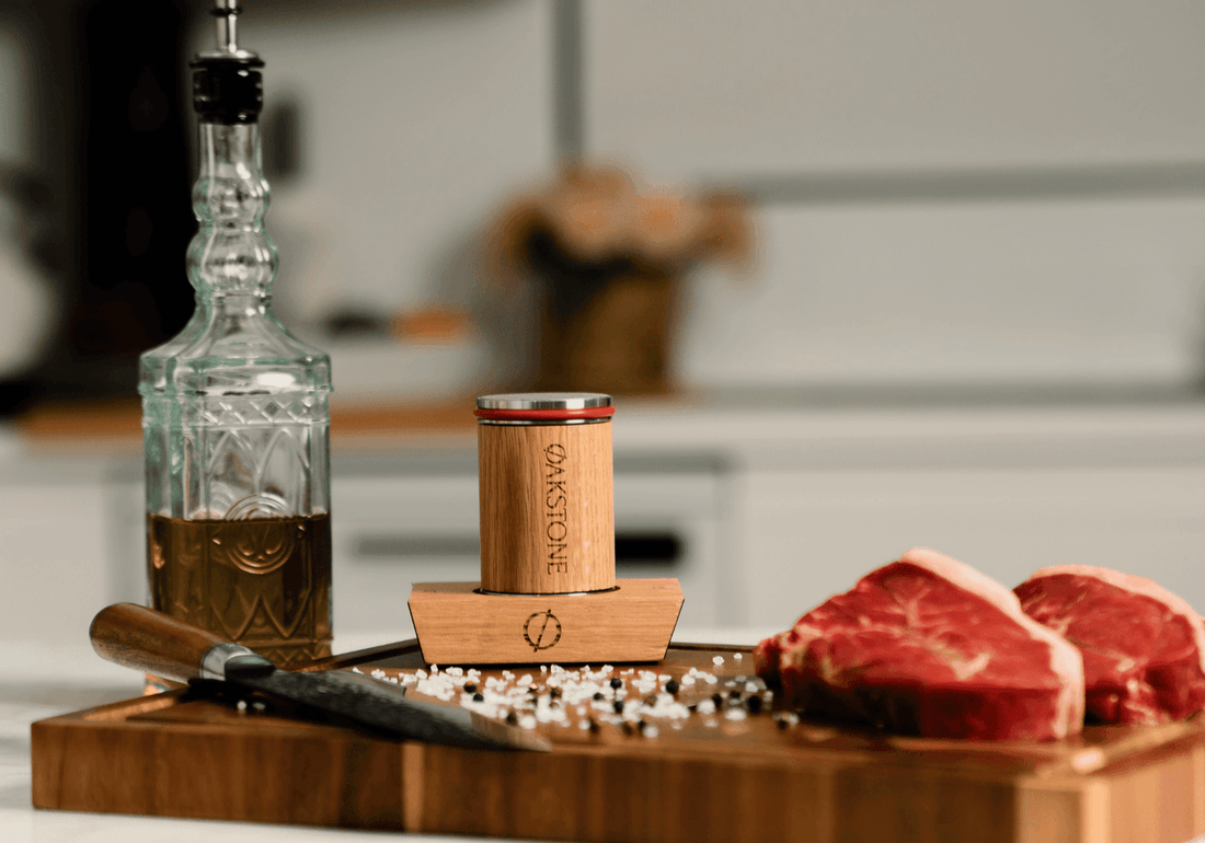Oakstone roller on a chopping board with raw meat, a knife and oil