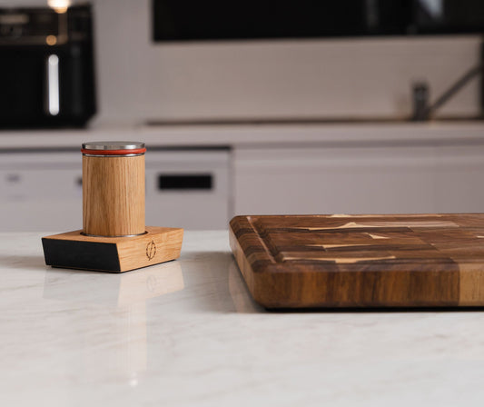 Oakstone sharpener base beside a wooden chopping board on a white bench