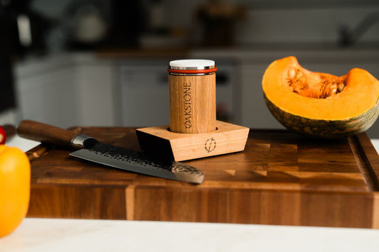 Knife beside a cut pumpkin on a wooden tray