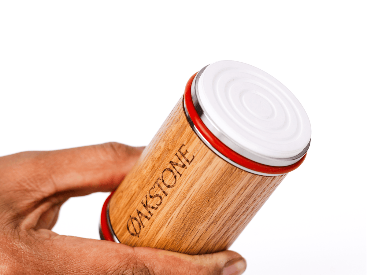 Hand holding the Oakstone oak roller engraved with the logo