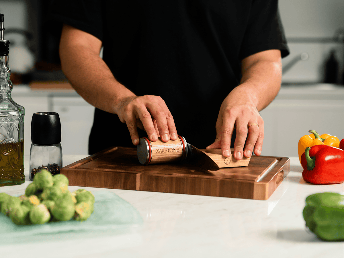 Oakstone rolling sharpener in use beside vegetables on a chopping board