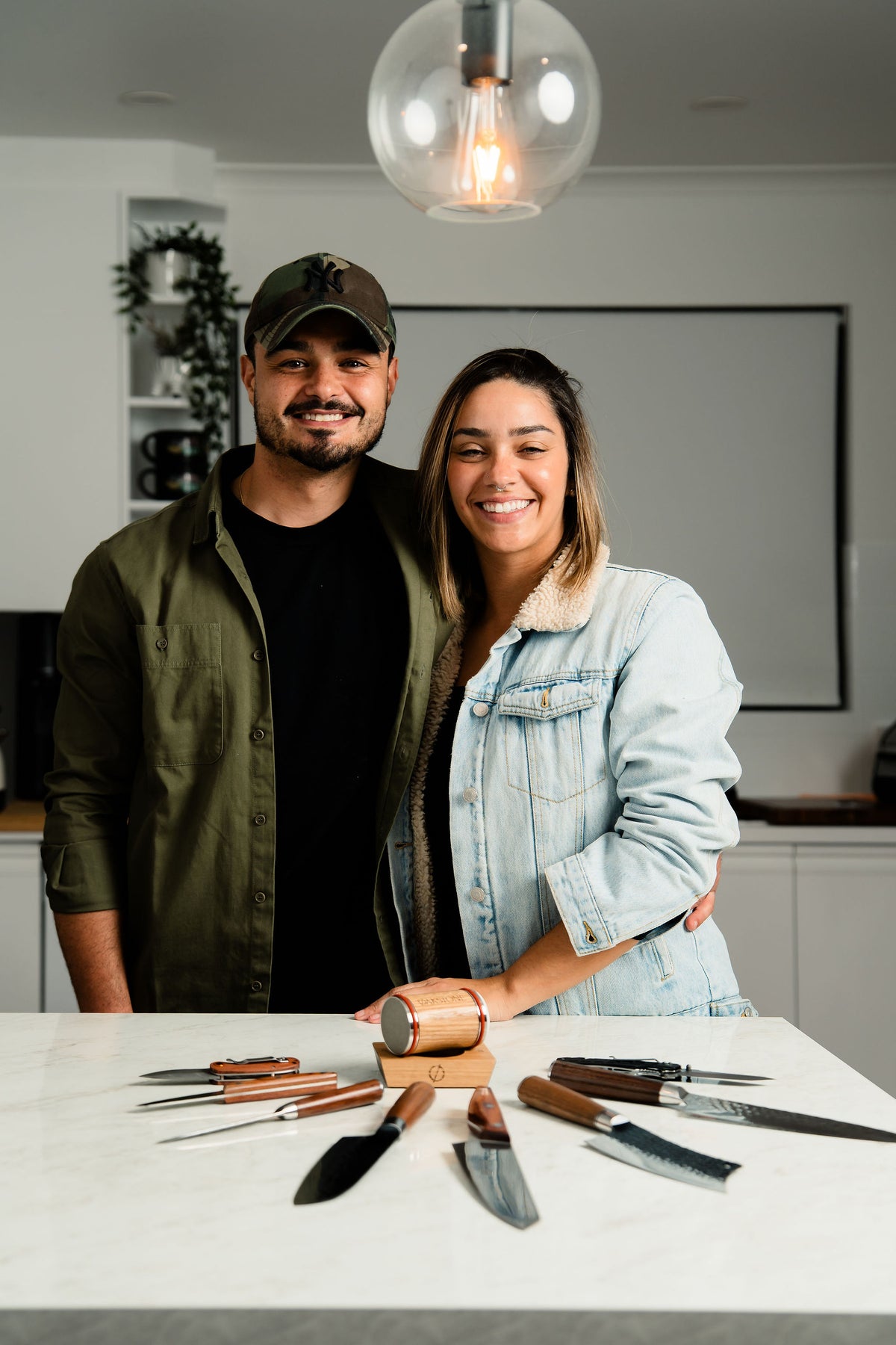 The Oakstone founders smiling and holding an Oakstone set